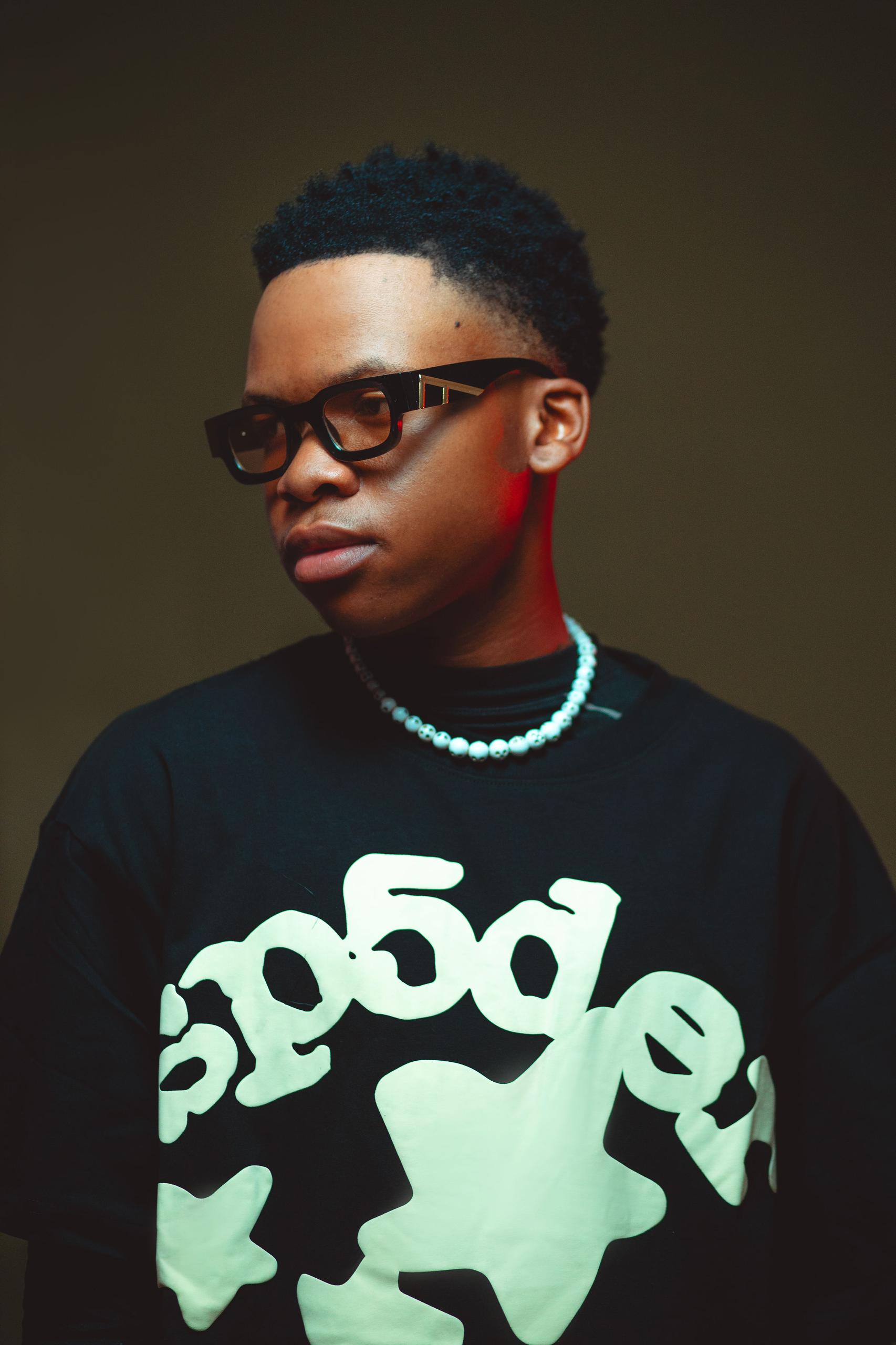 Sane.wav with glasses and pearl necklace